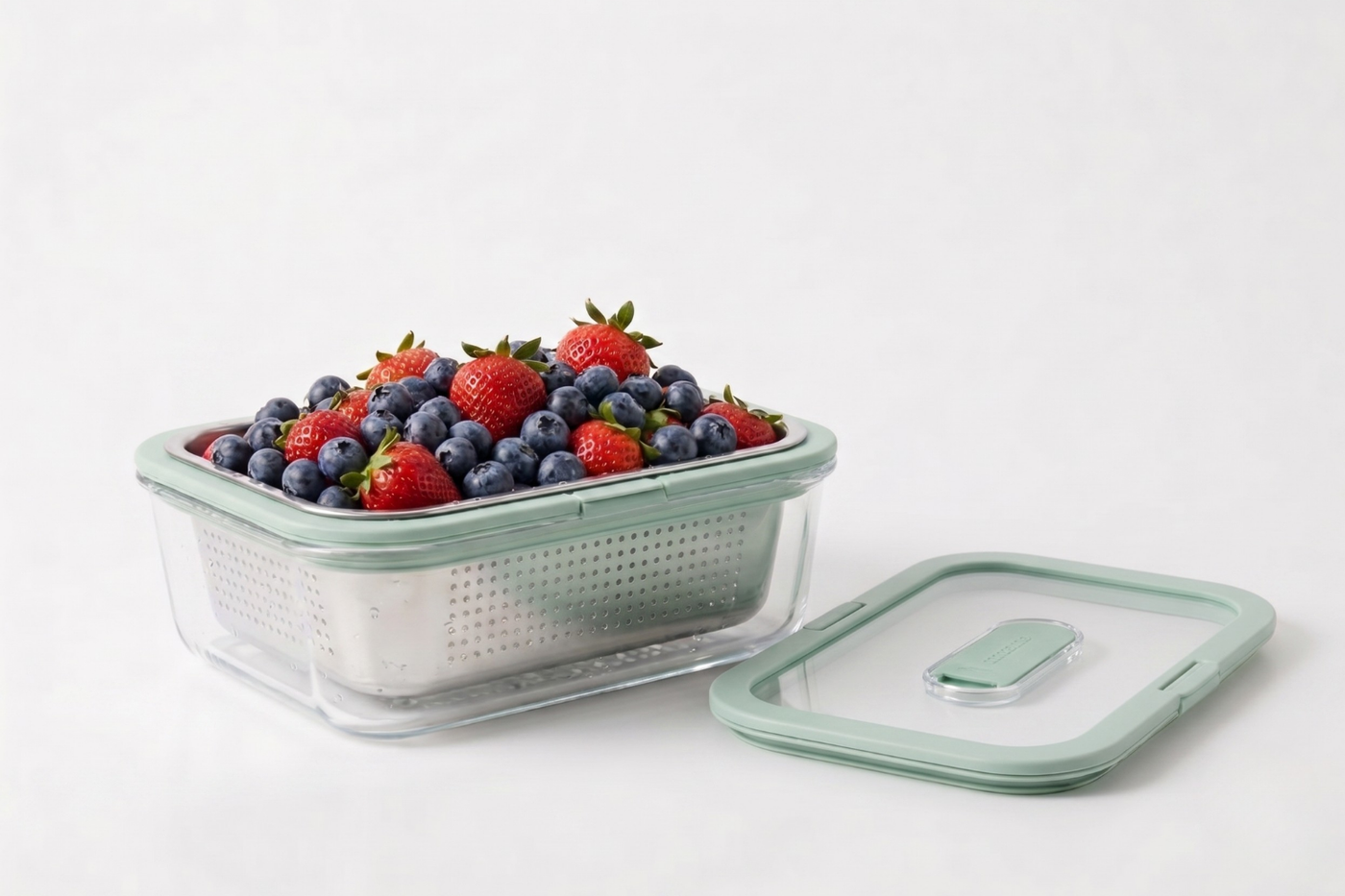 The Berry — glass container with stainless steel colander basket full of strawberries and blueberries